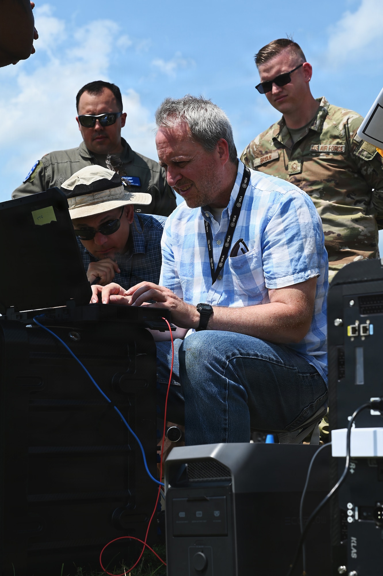 Members of the Air Force and Ohio Air National Guard look at laptops during field prototype testing evaluation for the Collaborative Combat Aircraft (CCA) Portable Command and Control Enclave (C2E).

(U.S. Air National Guard photo by Shane Hughes).