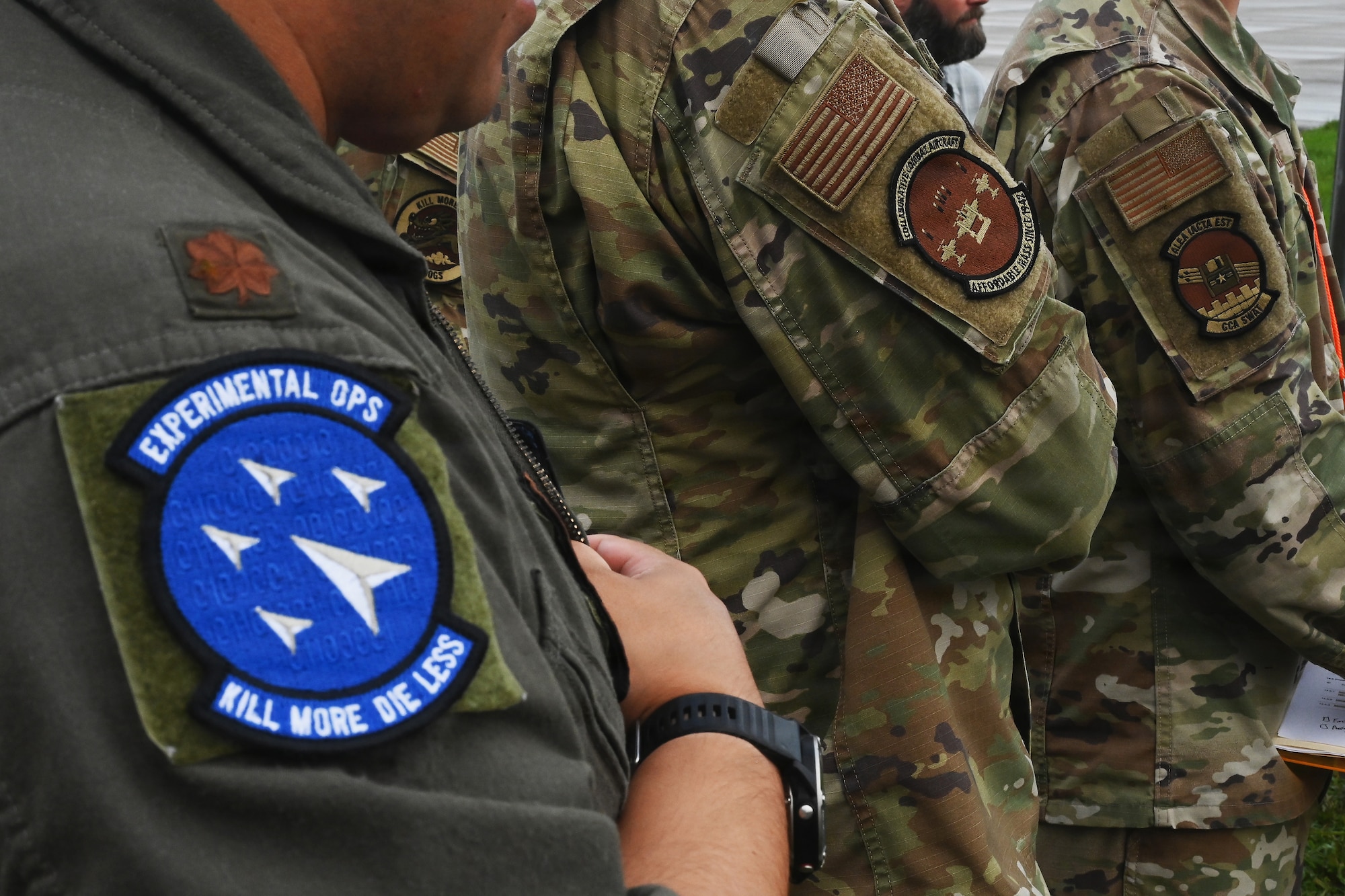 Members of the Air Force and Ohio Air National Guard look at laptops during field prototype testing evaluation for the Collaborative Combat Aircraft (CCA) Portable Command and Control Enclave (C2E).

(U.S. Air National Guard photo by Shane Hughes).