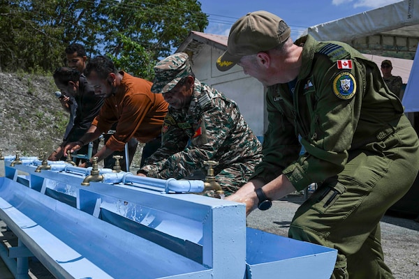 Canadian Armed Forces Col. Alain Lafrenière, right, deputy mission commander of Pacific Partnership 2026 (PP26), uses a newly installed handwashing station alongside members of the Timor-Leste Defence Force (F-FDTL) and Escola Básica Filial (EBF) Kasnafar administrators during a ribbon-cutting ceremony for a PP26 engineering line of effort construction project at EBF Kasnafar in Dili, Timor-Leste, Aug. 24, 2026. During the project, U.S. Navy Seabees assigned to Amphibious Construction Battalion (ACB) 1, alongside engineers from the Timor-Leste Defence Force, renovated an exterior school building and added a new water tank, increasing the school’s capacity to accommodate students and improving its facilities. Now in its 22nd iteration, the Pacific Partnership series is the largest annual multinational humanitarian assistance and disaster management preparedness mission conducted in the region. Pacific Partnership works collaboratively with host and partner nations to enhance regional interoperability and disaster response capabilities, increase security in the region, and foster new and enduring friendships in the Indo-Pacific. (U.S. Navy photo by Mass Communication Specialist 2nd Class T’ara Tripp)