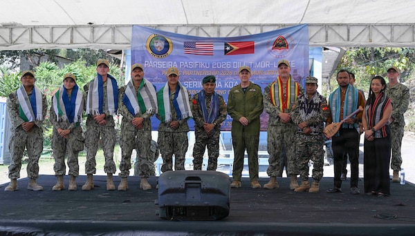 Canadian Armed Forces Col. Alain Lafrenière, center, deputy mission commander of Pacific Partnership 2026 (PP26), poses for a group photo with U.S. Navy Seabees, members of the Timor-Leste Defence Force (F-FDTL), and Escola Básica Filial (EBF) Kasnafar administrators after a ribbon-cutting ceremony for a PP26 engineering line of effort construction project at EBF Kasnafar in Dili, Timor-Leste, Aug. 24, 2026. During the project, U.S. Navy Seabees assigned to Amphibious Construction Battalion (ACB) 1, alongside engineers from the Timor-Leste Defence Force, renovated an exterior school building and added a new water tank, increasing the school’s capacity to accommodate students and improving its facilities. Now in its 22nd iteration, the Pacific Partnership series is the largest annual multinational humanitarian assistance and disaster management preparedness mission conducted in the region. Pacific Partnership works collaboratively with host and partner nations to enhance regional interoperability and disaster response capabilities, increase security in the region, and foster new and enduring friendships in the Indo-Pacific. (U.S. Navy photo by Mass Communication Specialist 2nd Class T’ara Tripp)