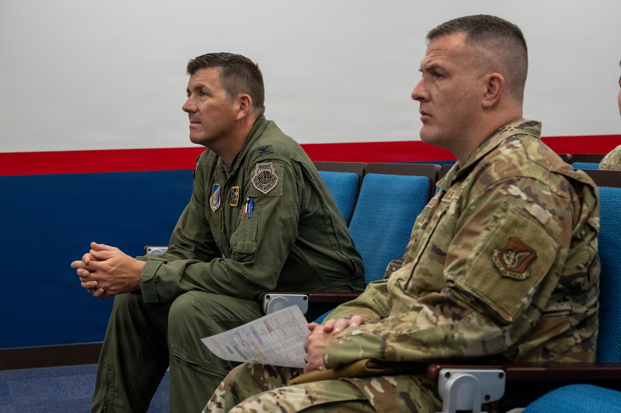 U.S. Air Force Col. Matthew T. Hoyt, 35th Fighter Wing (FW) deputy commander, left, and Chief Master Sgt. Jason T. Amaxopulos, 35th FW command chief, right, listen to a weapons control briefing during a Wild Weasel Walk-Through at Misawa Air Base, Japan, Aug. 24, 2026.
