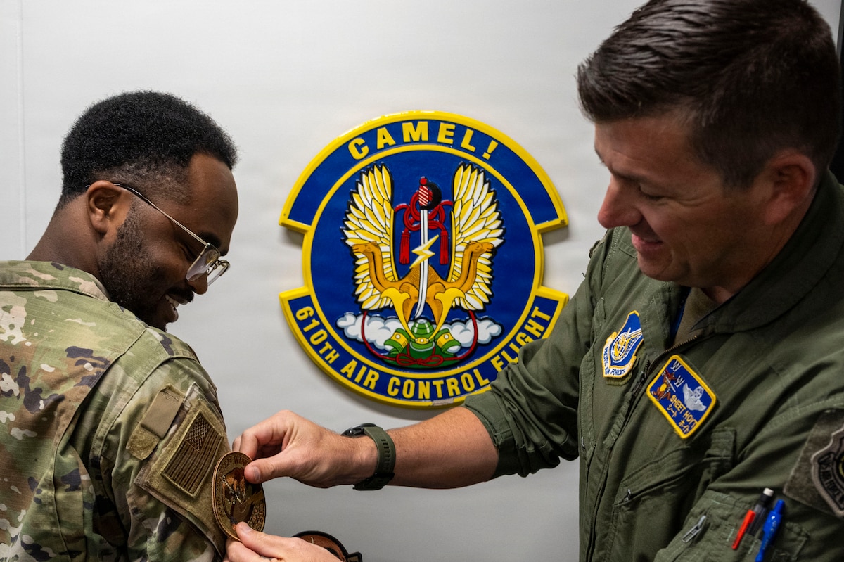 U.S. Air Force Col. Matthew T. Hoyt, 35th Fighter Wing deputy commander, right, presents a commander’s patch to Senior Airman Xavier Tanner, 610th Air Control Flight (ACF) weapons director, during a Wild Weasel Walk-Through at Misawa Air Base, Japan, Aug. 24, 2026.