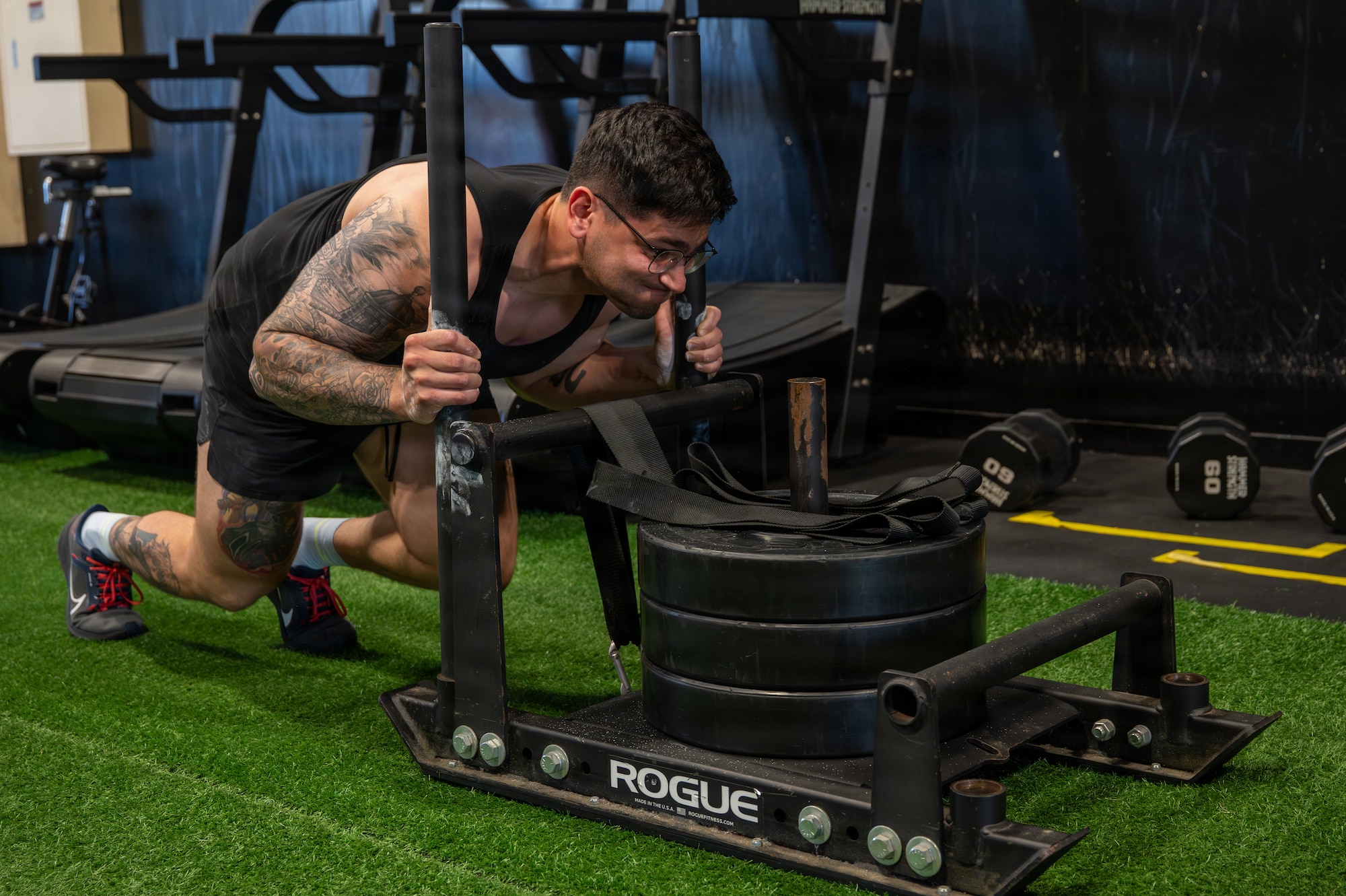 U.S. Air Force Staff Sgt. Alberto Rosendo-Diaz, 35th Security Forces Squadron military working dog handler, pushes a weighted sled during Misawa’s Strongest 100 competition at Misawa Air Base, Japan, Aug. 22, 2026. Physically demanding challenges provided participants an opportunity to test their limits and build the strength and stamina needed to perform effectively in demanding operational environments throughout the Pacific Theater. (U.S. Air Force photo by Airman 1st Class Angelica Winther)