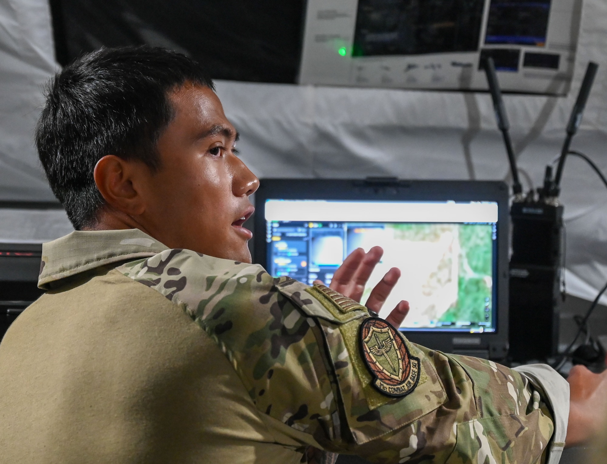 A U.S. Airman assigned to the 31st Air Task Force explains an AI-powered system that detects, tracks, and filters aerial objects during a capabilities demonstration with senior leaders from Air Force Special Operations Command near Hurlburt Field, Florida, Aug. 7, 2026. The week of training enhanced the unit's ability to provide early warning of potential airborne threats. (U.S. Air Force photo by 2nd Lt. Daniel White)