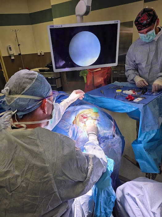 Image of surgeons treating a patient.