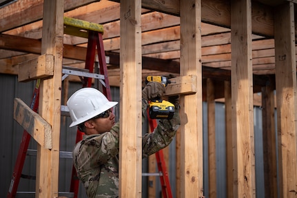 U.S. Air National Guard Senior Airman Ethan Gomez, a pavements and construction equipment specialist assigned to the 103d Civil Engineer Squadron, removes screws in a wooden beam during a demolition project at Seward Military Resort as part of a National Guard Bureau deployment for training, or DFT, on June 2, 2026, Seward, Alaska.