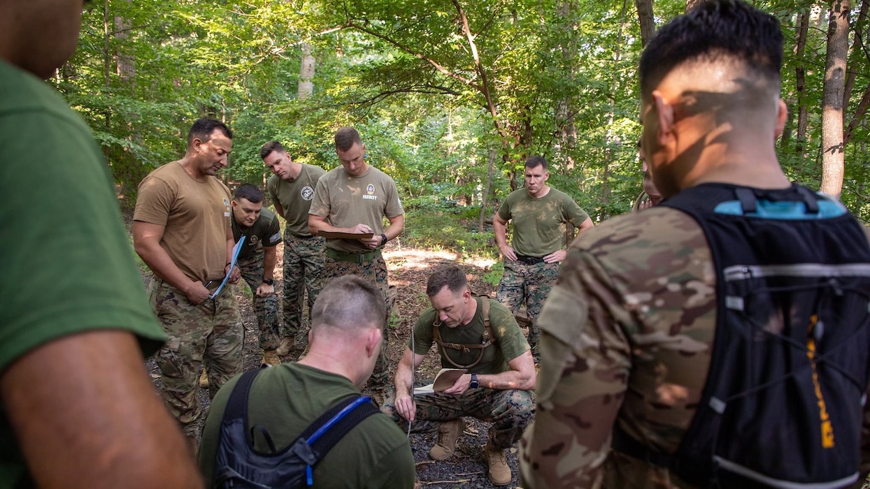 Expeditionary Warfare School students participate in Leadership Decision Making Exercise 1, a physically demanding training event that uses a Belleau Wood-based tactical scenario to develop leadership, teamwork, tactical decision-making, and communication skills. Students rotate through leadership billets, solve problems under time constraints, and lead their peers in a competitive tactical environment designed to reinforce maneuver-warfare principles and physical readiness.