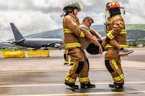 U.S. Air Force Master Sgt. David Denlis, a firefighter with the 121st Air Refueling Wing, and the Lajes Field Fire Department, simulate a motor vehicle accident scenario at Lajes Field, Portugal, on Aug. 10, 2026.