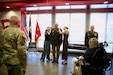 Anna and Emma Armstrong pin the rank insignia of brigadier general onto the shoulders of their father, Col. Michael Armstrong, during a promotion ceremony at Western Kentucky University in Bowling Green, Kentucky, Aug. 23, 2026. Armstrong, a career Army National Guard aviator and 2001 graduate of WKU’s ROTC program, celebrated his promotion alongside family, friends, and state military leadership at the university where his military service first began. (U.S. Army National Guard photo by Sgt. Georgia Napier)