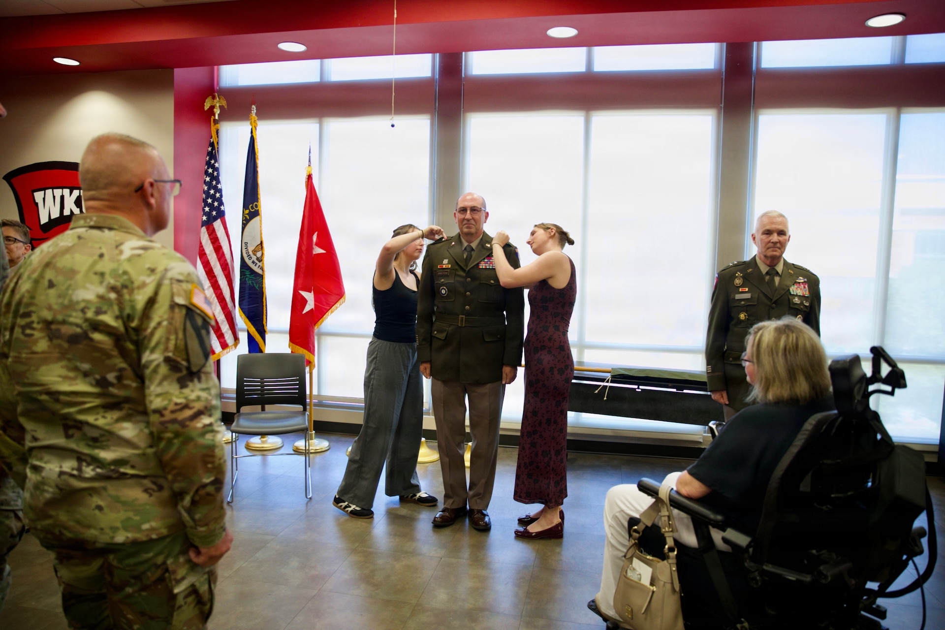 Anna and Emma Armstrong pin the rank insignia of brigadier general onto the shoulders of their father, Col. Michael Armstrong, during a promotion ceremony at Western Kentucky University in Bowling Green, Kentucky, Aug. 23, 2026.