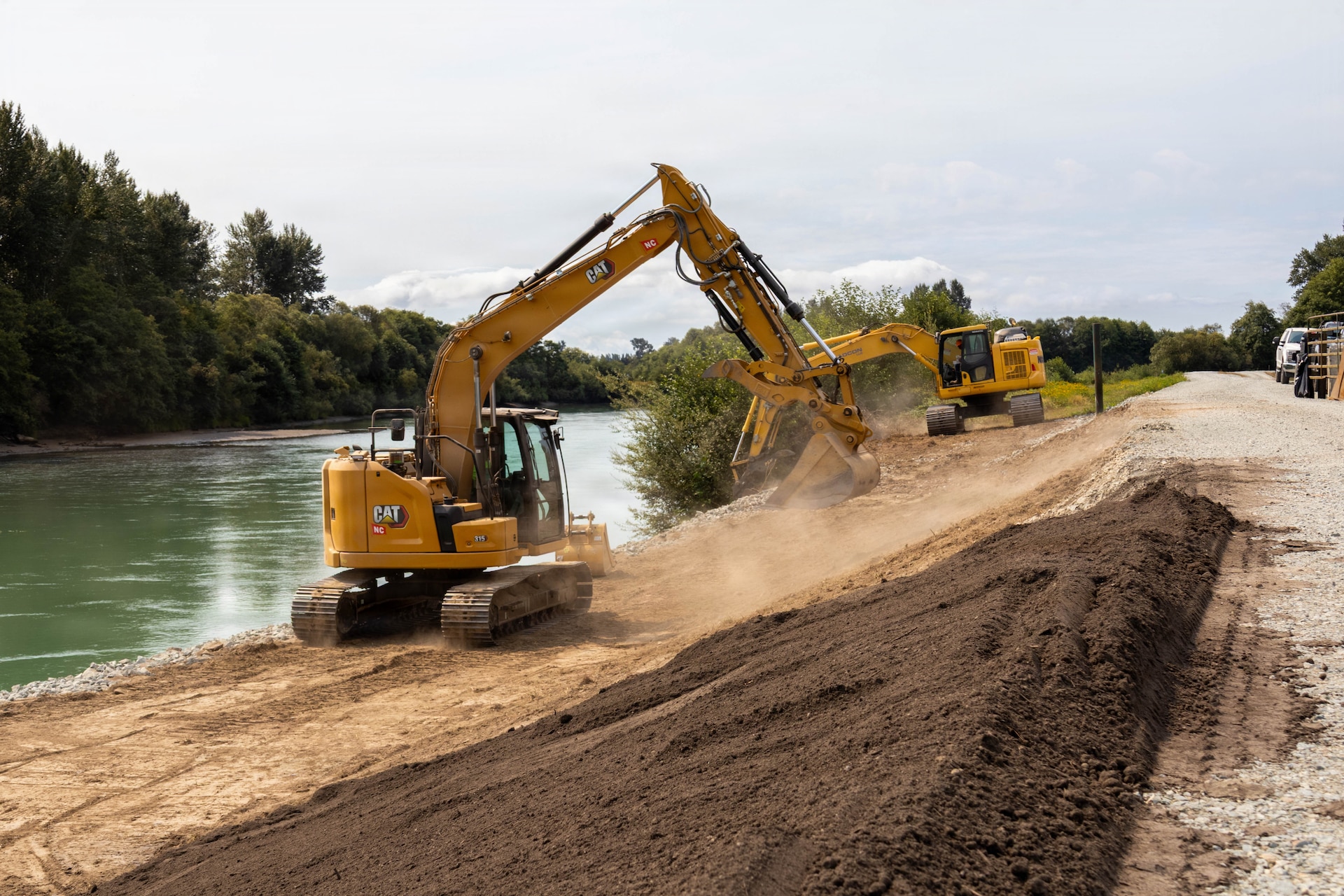 Photo of a bulldozer, moving materials during undergoing levee repair operations at a levee site.