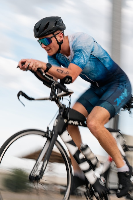 An athlete rides his bike during a sprint triathlon at Altus Air Force Base, Oklahoma, Aug. 22, 2026. After completing the 20- kilometer cycling portion, competitors transitioned to the final 5- kilometer run. (U.S. Air Force photo by Senior Airman Jonah Bliss)