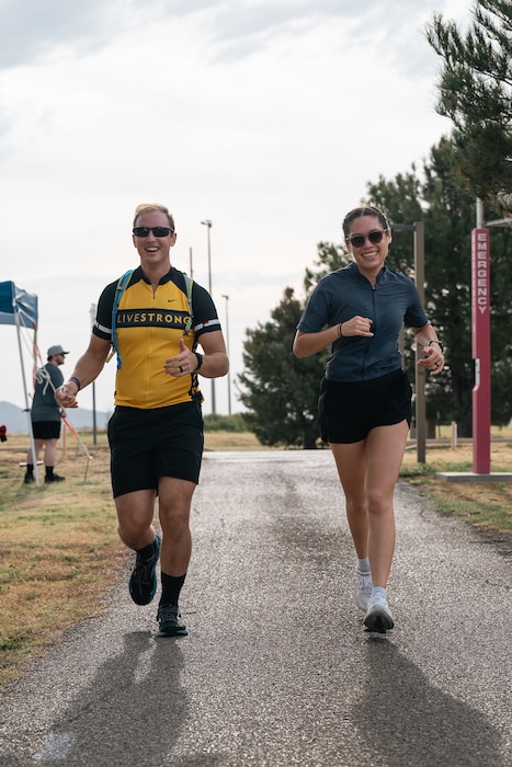 Athletes run during a sprint triathlon at Altus Air Force Base, Oklahoma, Aug. 22, 2026. Competitors completed the final five kilometers of the event after swimming and cycling. (U.S. Air Force photo by Senior Airman Jonah Bliss)