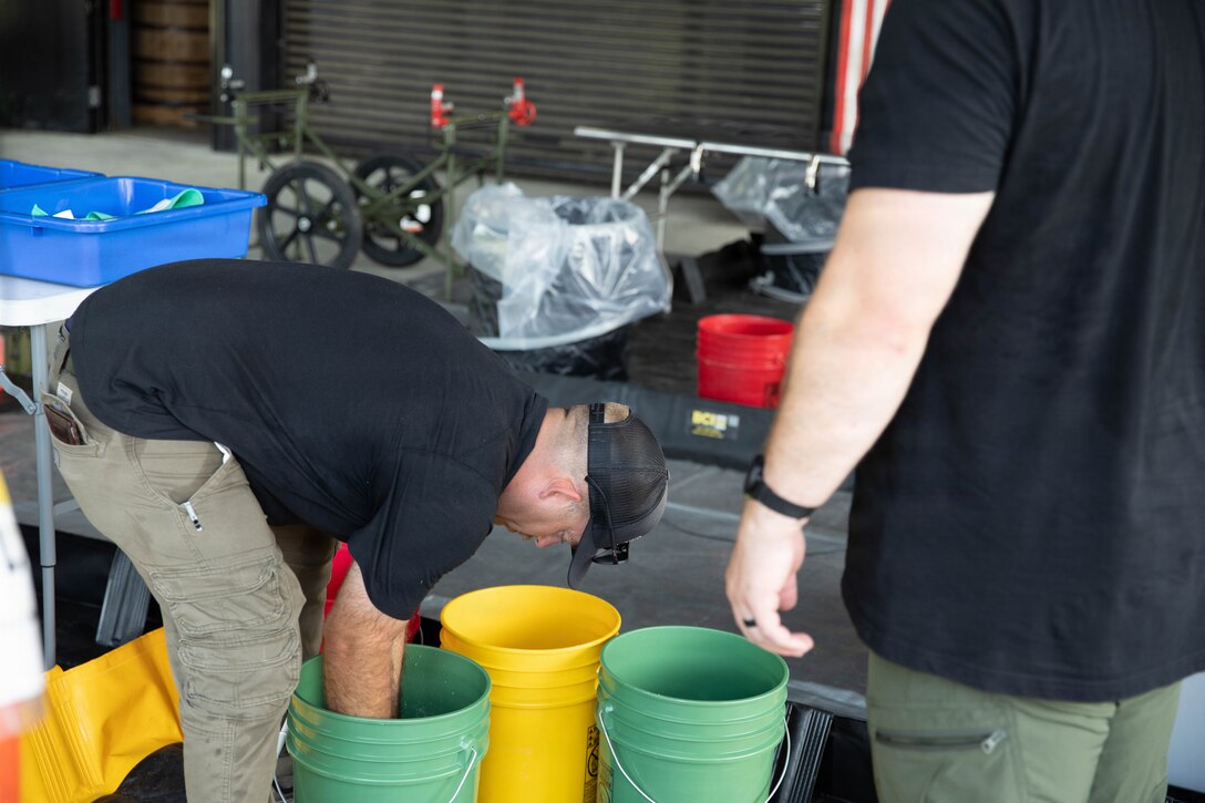 U.S. Army Sgt. 1st Class Christopher Ramsey prepares a decontamination area prior to a training exercise at Jim Beam Distillery Booker Noe Plant in Boston, Kentucky, Aug. 11, 2026.