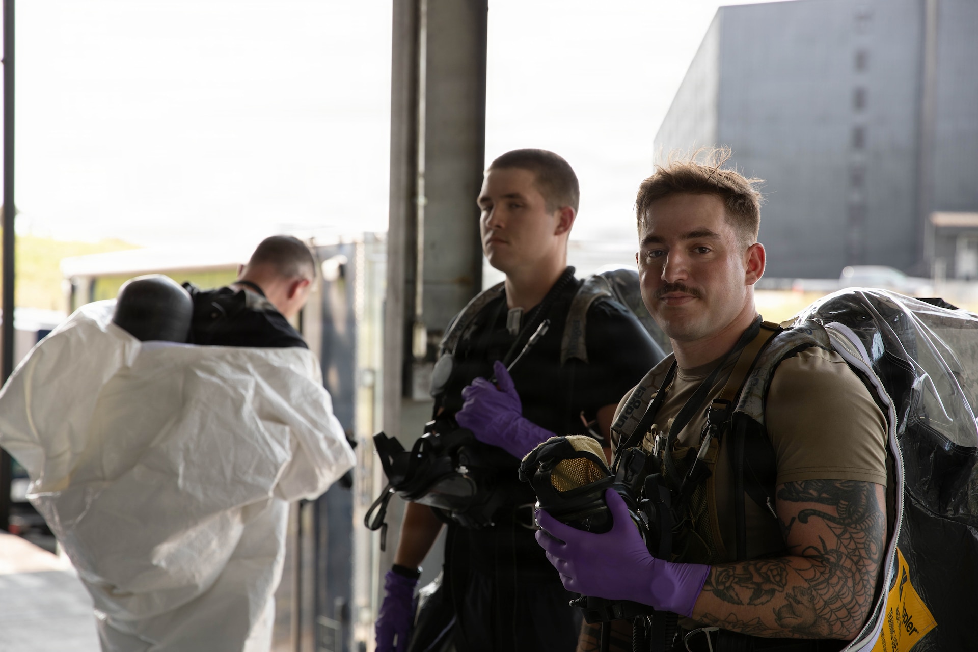 U.S. Air Force Senior Airman Caleb Powell, U.S. Army Sgt. Dylan TrueHeart and Staff Sgt. Zachary Baise, members of Kentucky National Guard’s 41st Civil Support Team (CST), prepare to make entry into a warehouse during a training scenario at Jim Beam Distillery Booker Noe Plant in Boston, Kentucky, Aug. 11, 2026.