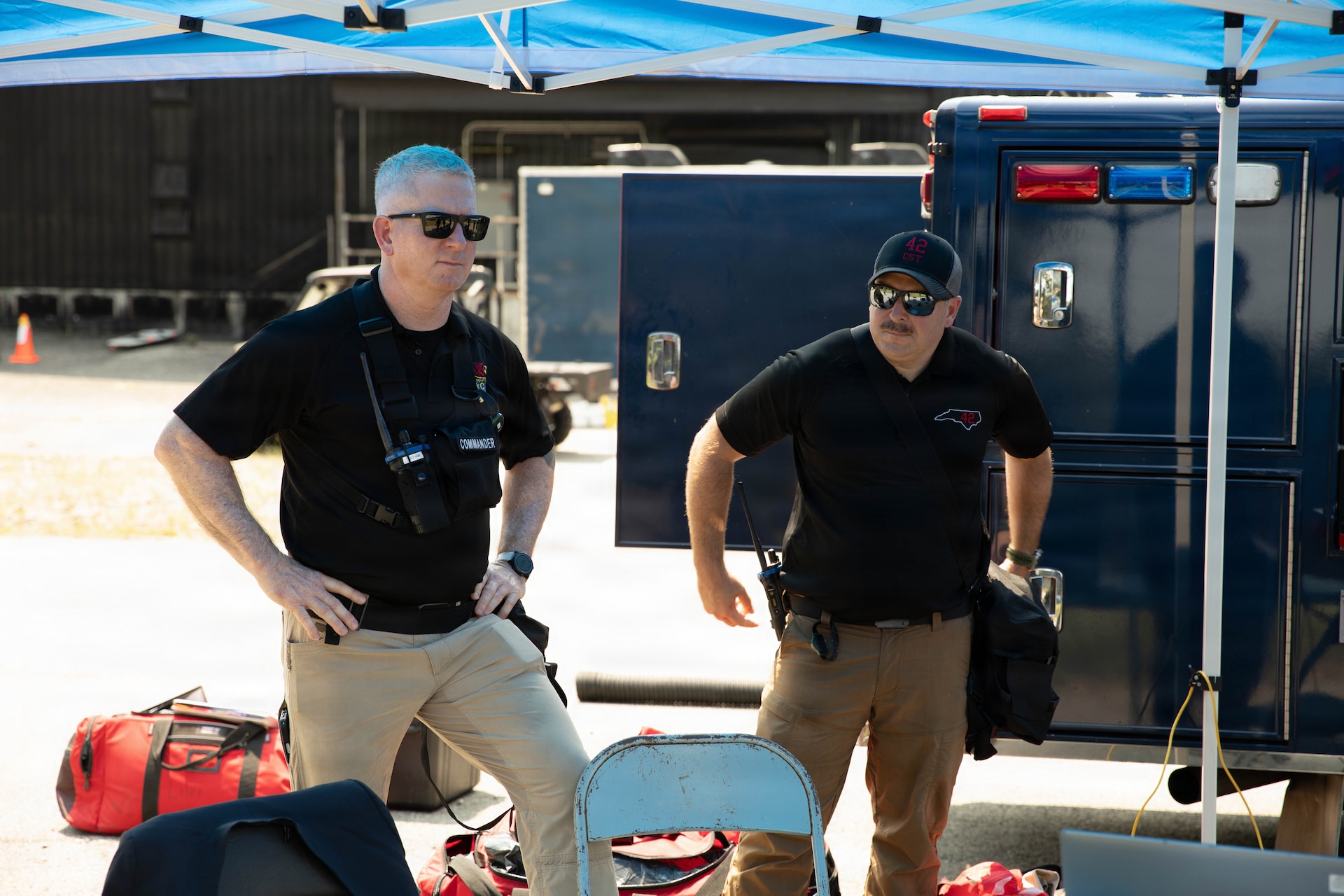 U.S. Army Lt. Col. Patrick Mohan, commander of North Carolina’s 42nd Civil Support Team (CST), and Maj. John Johnson, deputy commander, look on as members of the unit prepare for a training scenario at Jim Beam Distillery Booker Noe Plant in Boston, Kentucky, Aug. 11, 2026.