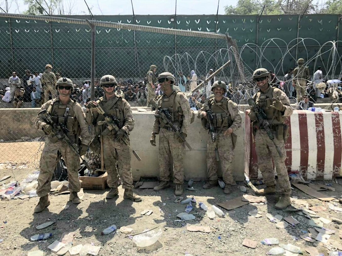 U.S. Marines with Golf Company, 2nd Platoon, 1st Marine Division, pose for a photograph at Hamid Karzai International Airport during Non-combatant Evacuation Operations in Kabul, Afghanistan, 2021. The photo was taken prior to the suicide bombing at Abbey Gate while Marines secured the airfield and processed evacuees. (Courtesy photo by Lance Cpl. Noah Smith)