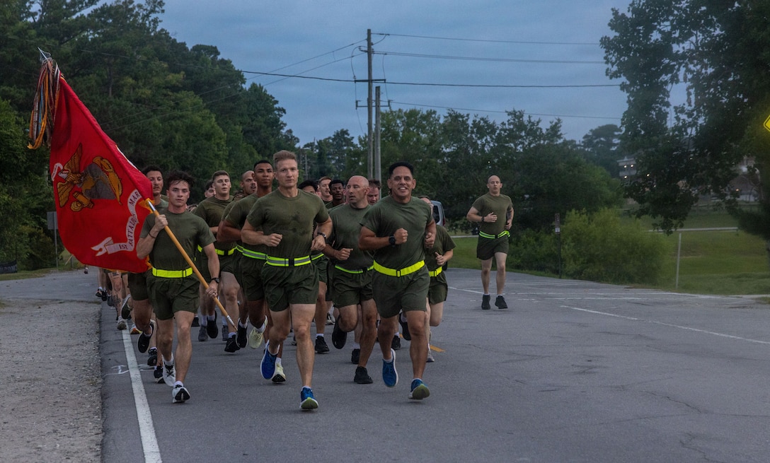 U.S. Marines with 1st Battalion, 6th Marine Regiment conduct a motivational run on Marine Corps Base Camp Lejeune, North Carolina, July 9, 2026. The ceremony honored the 109th birthday by reflecting the esprit de corps within 1st Bn., 6th Marines, paying homage to the service and sacrifice of Marines and Sailors both past and present. (U.S. Marine Corps photo by Lance Cpl. Isabelle C. Hutmacher)
