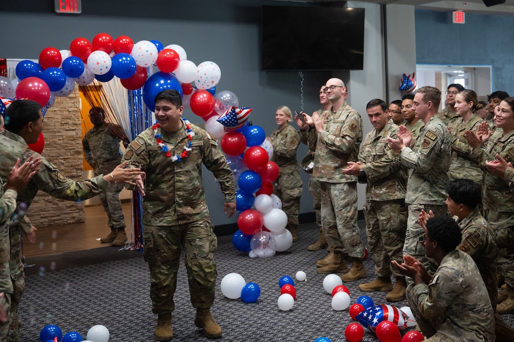 U.S. Air Force Senior Airman Kadenjoseph Lizama, 17th Training Support Squadron unit security assistant, walks through the gauntlet during a staff sergeant release party at Goodfellow Air Force Base, Texas, Aug. 21, 2026. The gauntlet is a tradition where family members, friends and coworkers congratulate Airmen selected for promotion to staff sergeant (U.S. Air Force photo by Senior Airman Brian Lummus)