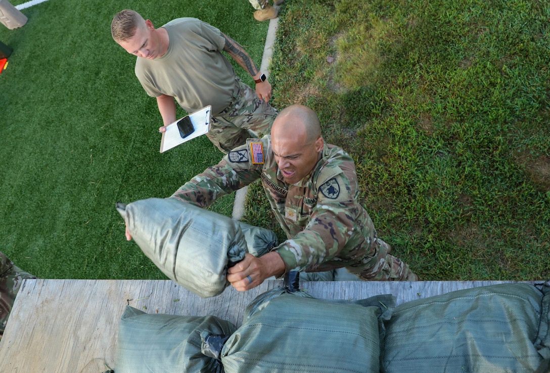 U.S. Army Maj. Michael Reinersman throws sandbags during the Combat Field Test (CFT), which was administered during the Kentucky National Guard’s Iron Major Leader Development Day at the Wendell H. Ford Regional Training Center in Greenville, Kentucky, Aug. 15, 2026.