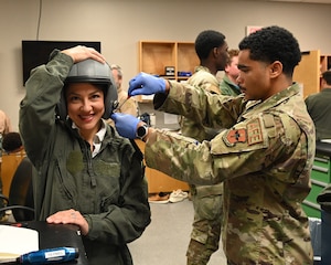Brittany Cofield, Columbus Chick-Fil-A, owner/operator, is fitted for a head gear unit during uniform and equipment sizing in preparation for a T-6 Texan II orientation flight on June 6, 2026, at Columbus Air Force Base, Mississippi. Coefield was part of a new civic outreach and engagement initiative established by the installation commander, Col. James Blech, to immerse community leaders in the daily challenges of student pilots completing pilot training at Columbus AFB. (U.S. photo by Melissa Duncan-Doublin)