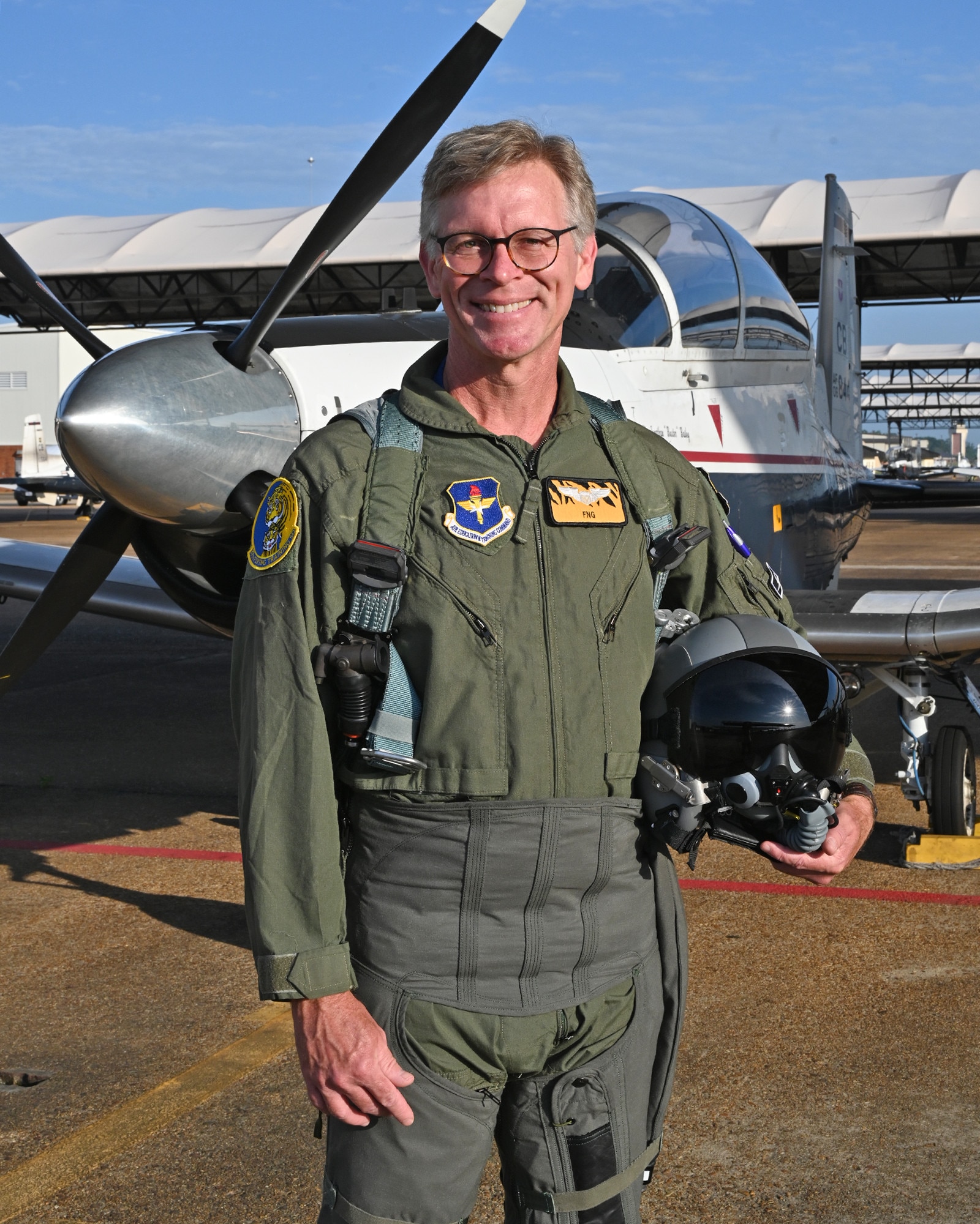 Thomas Easterling, The Mississippi School for Mathematics and Science, Director for Academic Affairs, stands for a photo in front of a T-6 Texan II aircraft before his orientation flight on June 6, 2026, at Columbus Air Force Base, Mississippi. Easterling was part of a new civic outreach and engagement initiative established by the installation commander, Col. James Blech, to immerse community leaders in the daily challenges of student pilots completing pilot training at Columbus AFB. (U.S. photo by Melissa Duncan-Doublin)