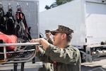 A U.S. Marine with the Chemical Biological Incident Response Force (CBIRF) inventories equipment on a rescue vehicle during the Freedom 250 Grand Prix in Washington, D.C., Aug. 23, 2026. CBIRF enhanced its operational readiness to support contingency operations during the high-visibility event.  (DoW photo by Prentice Colter)