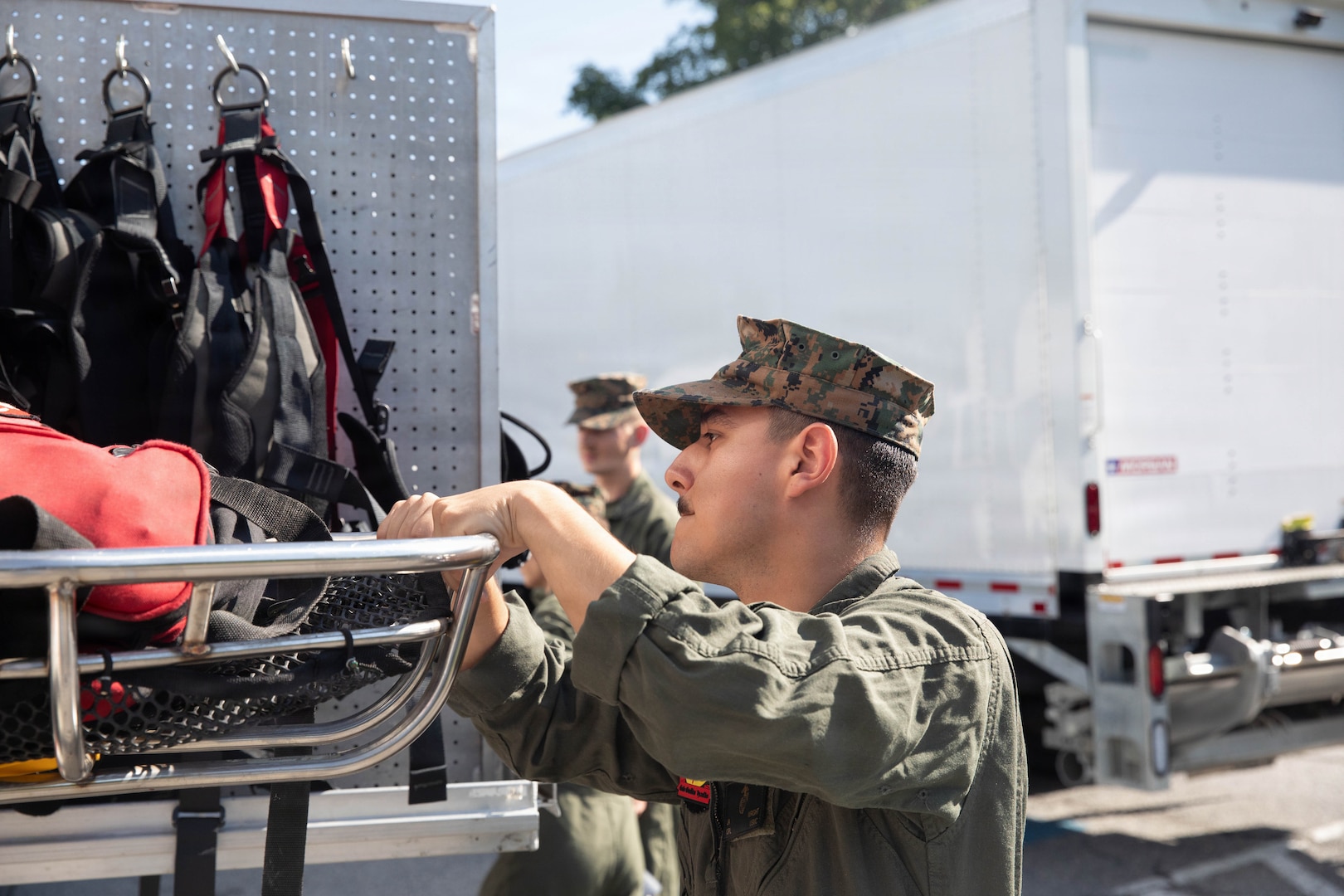 A U.S. Marine with the Chemical Biological Incident Response Force (CBIRF) inventories equipment on a rescue vehicle during the Freedom 250 Grand Prix in Washington, D.C., Aug. 23, 2026. CBIRF enhanced its operational readiness to support contingency operations during the high-visibility event.  (DoW photo by Prentice Colter)