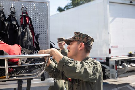 A U.S. Marine with the Chemical Biological Incident Response Force (CBIRF) inventories equipment on a rescue vehicle during the Freedom 250 Grand Prix in Washington, D.C., Aug. 23, 2026. CBIRF enhanced its operational readiness to support contingency operations during the high-visibility event.  (DoW photo by Prentice Colter)