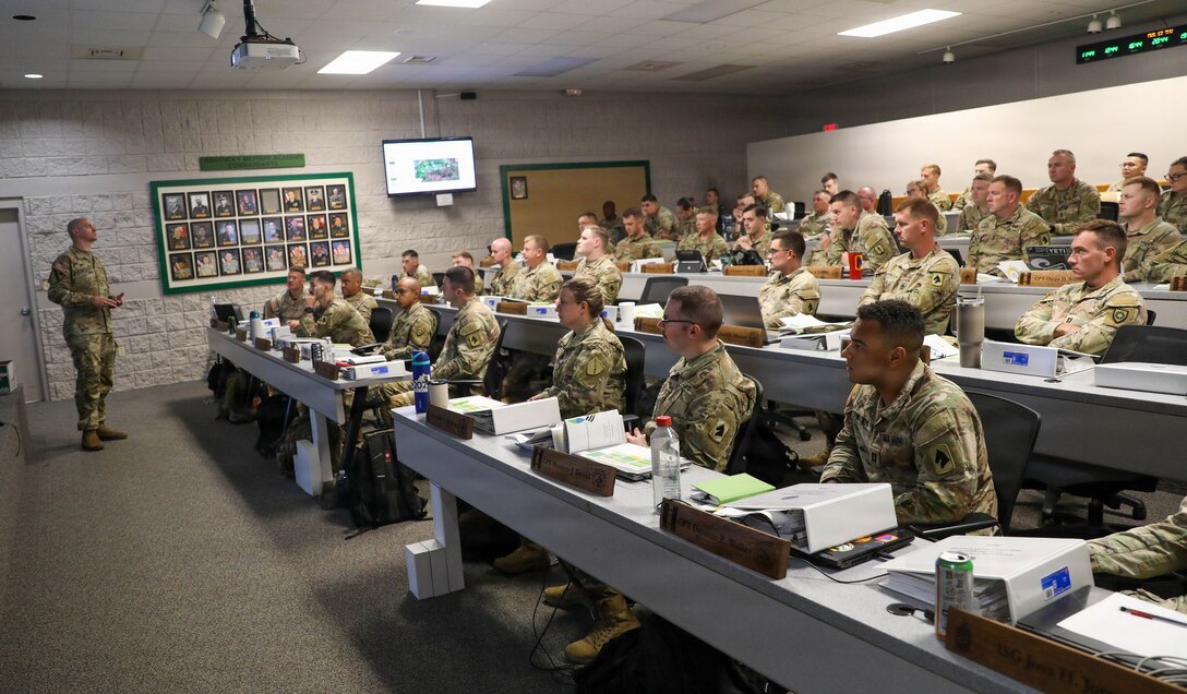 Kentucky National Guard officers and senior noncommissioned officers listen to U.S. Army Sgt.1st Class Reid Smith, senior operations noncommissioned officer for the Garrison Training Command, as he delivers remarks during the pre-command course at Wendell H. Ford Regional Training Center in Greenville, Kentucky, Aug. 13, 2026.