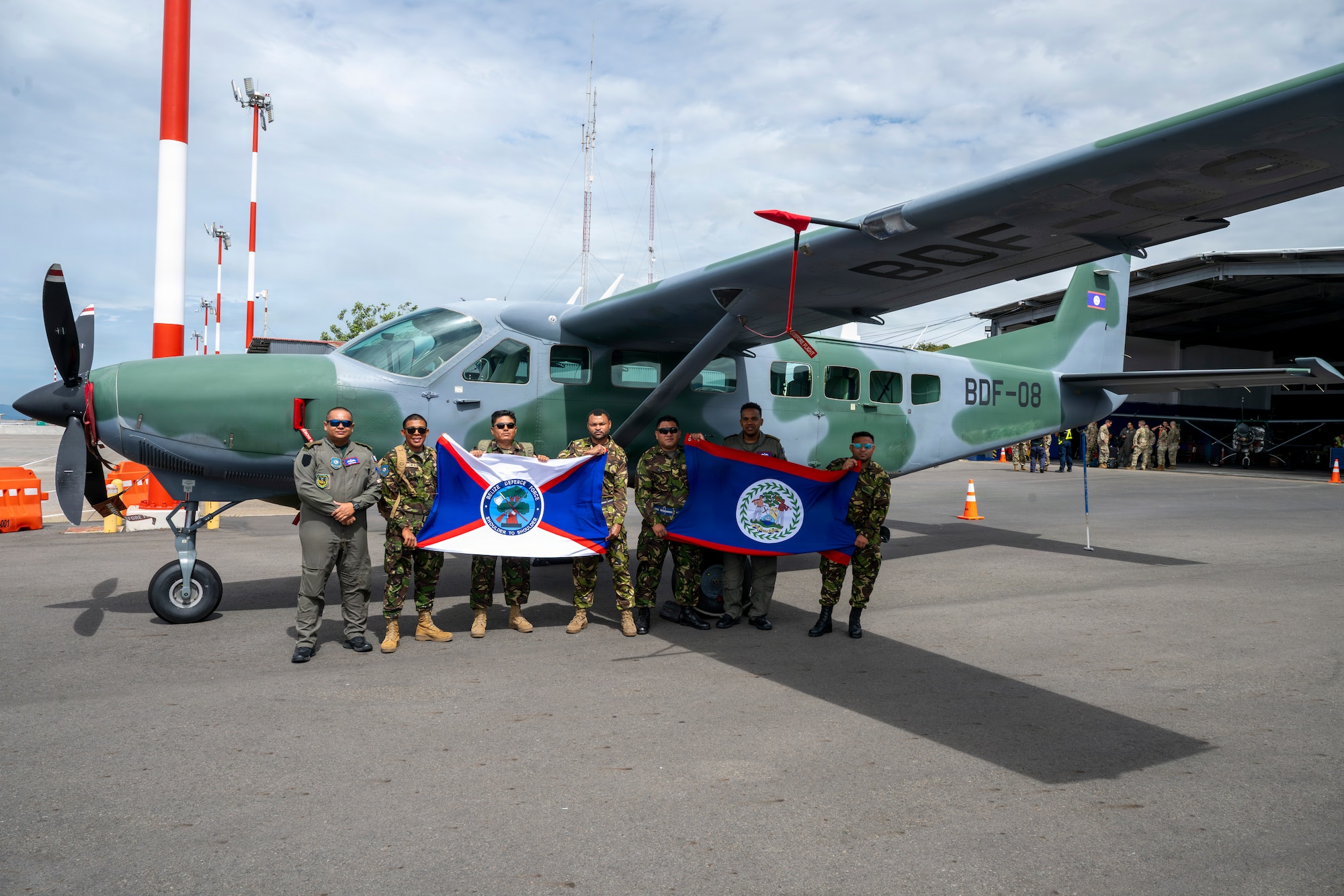 Men pose with flags.