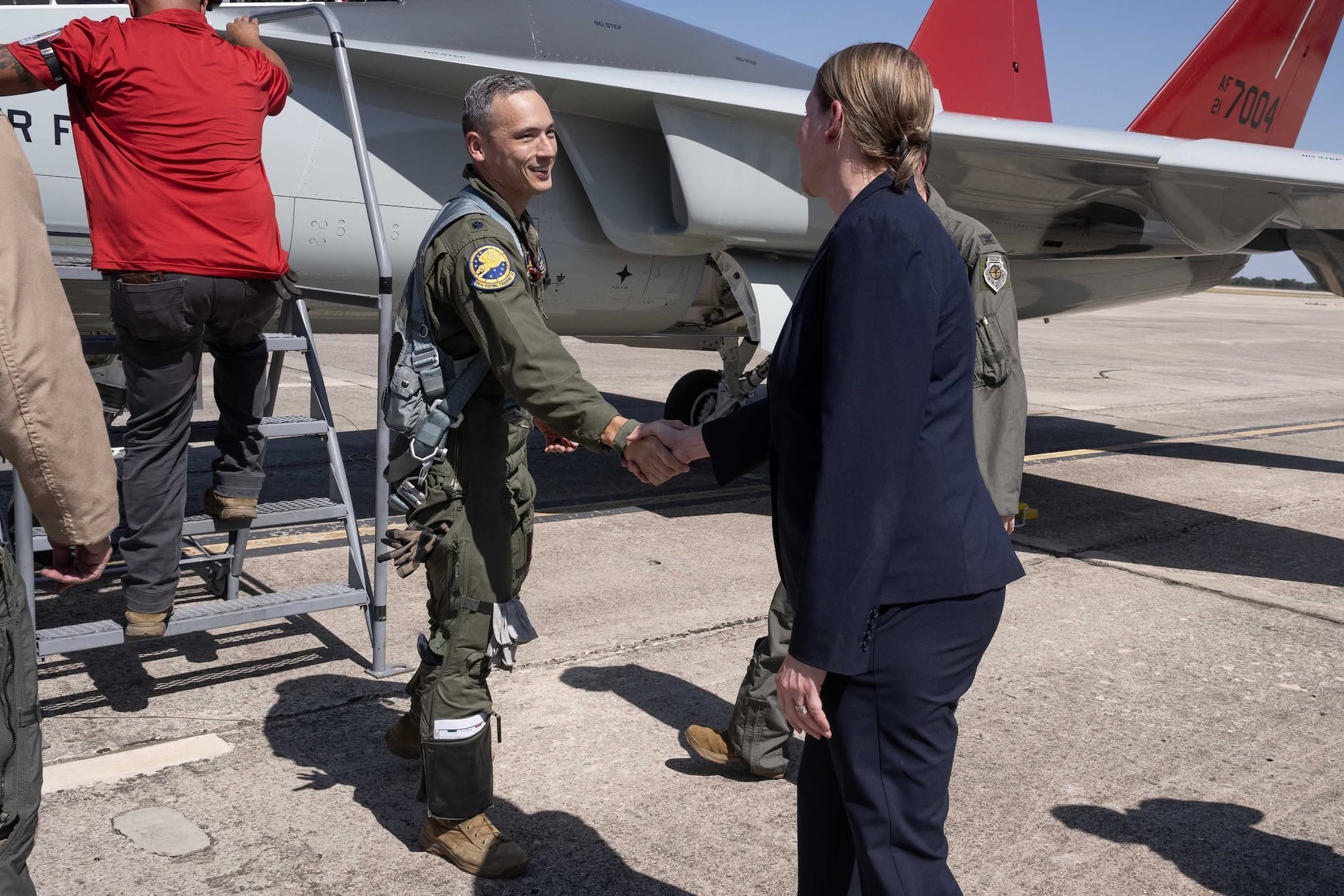 A T-7A Redhawk pilot greets personnel