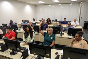 A class of people engage in training.
