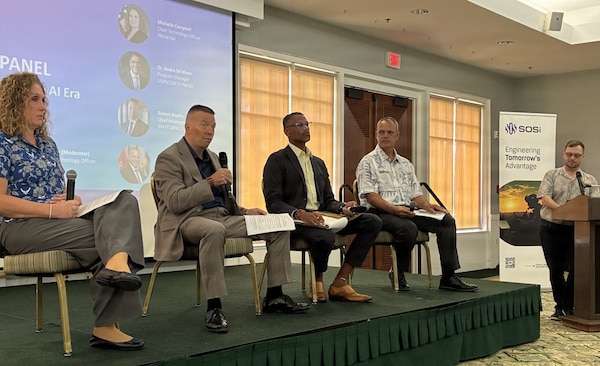 From left, Michelle Campbell, Pacific Air Forces chief technology officer; Robert Sholtis, chief information officer and deputy G-6, U.S. Marine Corps Forces, Pacific; Dr. Andre Stridiron, U.S. Pacific Command J7 Pacific Multi-Domain Training and Experimentation Capability program manager; and Richard Williams, U.S. Pacific Fleet technical director for communications and information systems, participate in a panel discussion moderated by Kyle Fox, standing right, SOSi chief technology officer, during the Armed Forces Communications and Electronics Association Hawaii Tech Talk at Joint Base Pearl Harbor-Hickam, Hawaii, Aug. 4, 2026.