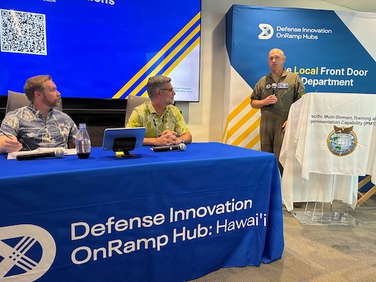 Air Force Col. Matthew C. Gaetke, U.S. Pacific Command (US PACOM) J7 director of training and exercises, welcomes participants, including panelists Andrew Emslie, US PACOM J7 Pacific Multi-Domain Training and Experimentation Capability (PMTEC) space integrator, and Jamie Giambrone, U.S. Army Pacific deputy director of training, to the PMTEC Quarterly Commercial Industry Update in Honolulu, Aug. 6, 2026.