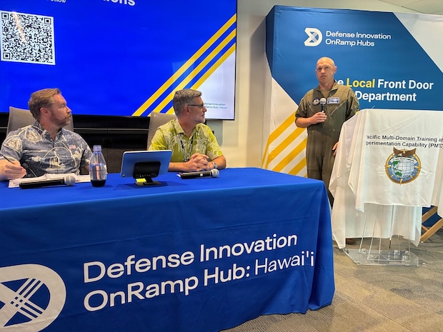 Air Force Col. Matthew C. Gaetke, U.S. Pacific Command (US PACOM) J7 director of training and exercises, welcomes participants, including panelists Andrew Emslie, US PACOM J7 Pacific Multi-Domain Training and Experimentation Capability (PMTEC) space integrator, and Jamie Giambrone, U.S. Army Pacific deputy director of training, to the PMTEC Quarterly Commercial Industry Update in Honolulu, Aug. 6, 2026.