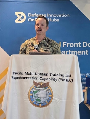 Navy Cmdr. David Yancey, Space Development Agency Pacific deputy director, briefs participants on the integration of the Proliferated Warfighter Space Architecture (PWSA) during the U.S. Pacific Command (US PACOM) J7 Pacific Multi-Domain Training and Experimentation Capability Quarterly Commercial Industry Update in Honolulu, Aug. 6, 2026.