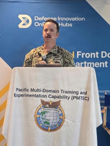 Navy Cmdr. David Yancey, Space Development Agency Pacific deputy director, briefs participants on the integration of the Proliferated Warfighter Space Architecture (PWSA) during the U.S. Pacific Command (US PACOM) J7 Pacific Multi-Domain Training and Experimentation Capability Quarterly Commercial Industry Update in Honolulu, Aug. 6, 2026.