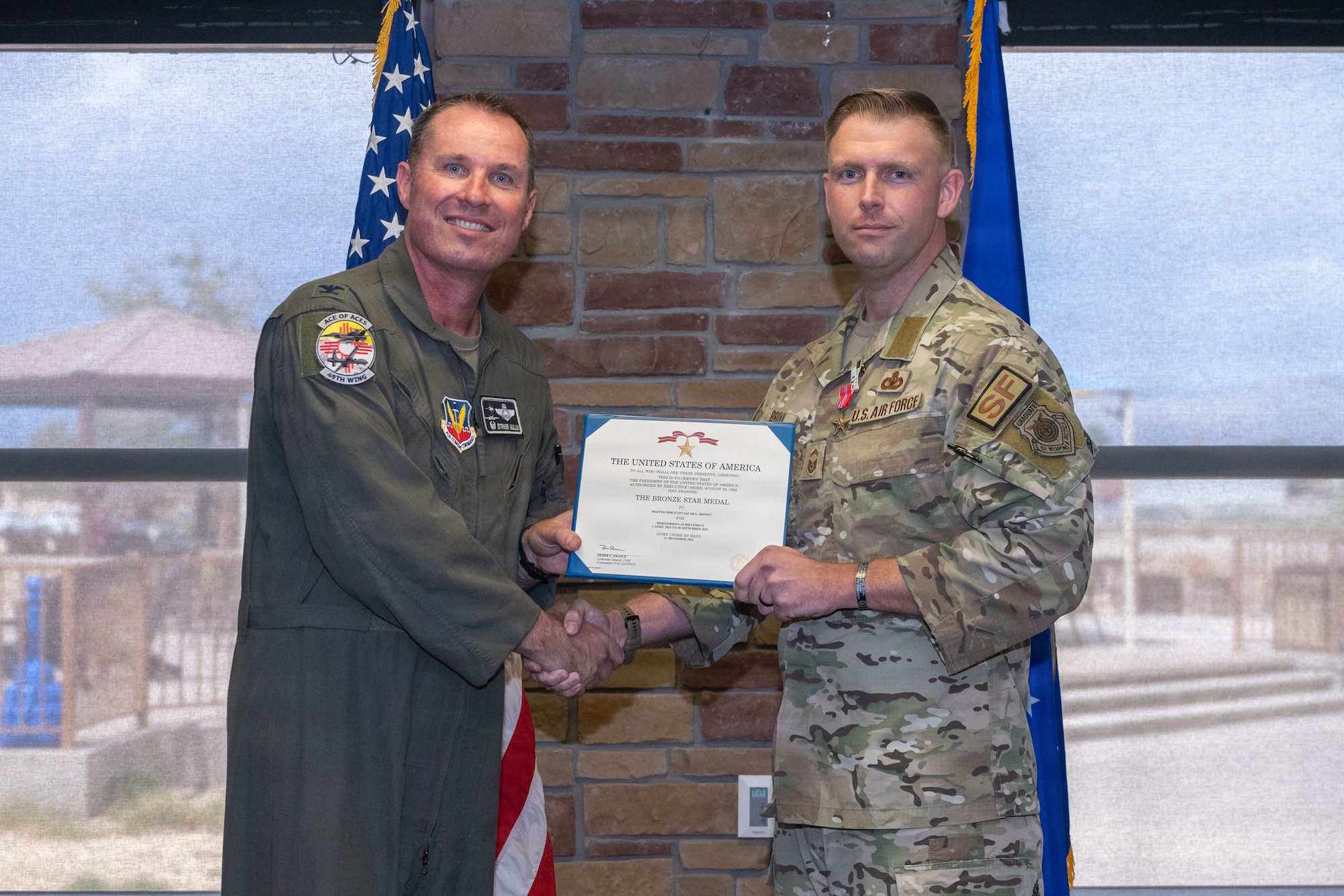 U.S. Air Force Senior Master Sgt. Jacob Brown, 49th Security Forces Squadron base superintendent, receives the Bronze Star Medal during the 49th Wing Security Forces Decoration Ceremony at Holloman Air Force Base, New Mexico, July 10, 2026. While deployed, Brown supported operations in the U.S. Central Command area of responsibility. (U.S. Air Force photo by Airman 1st Class Elijah Strickland)