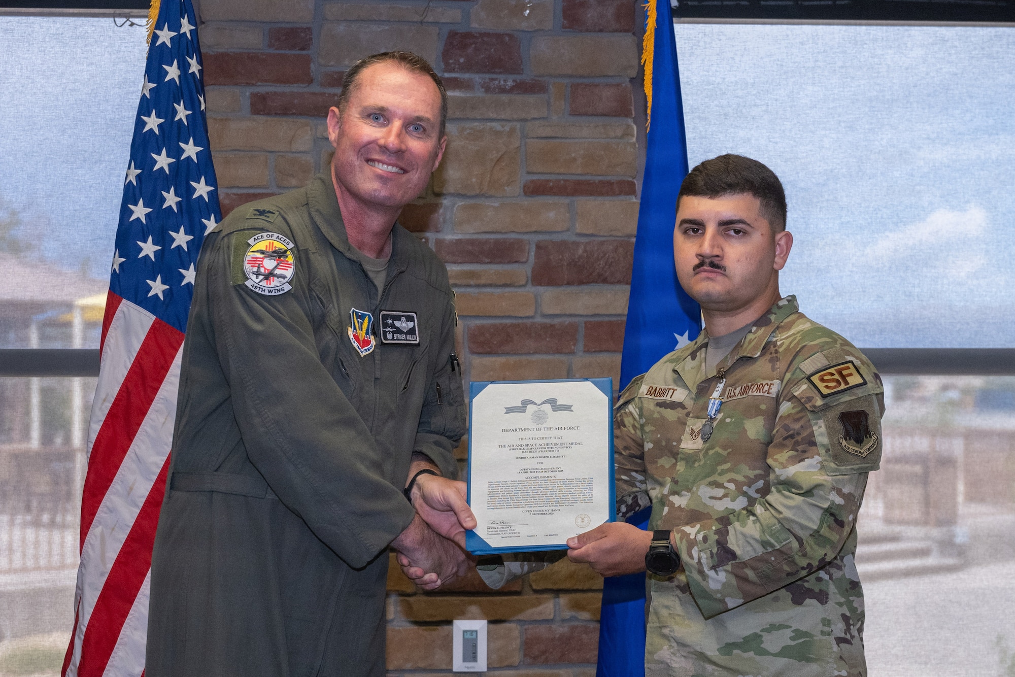 U.S. Air Force Staff Sgt. Joseph Babbit, 49th Security Forces Squadron response force leader, receives the Air and Space Achievement Medal with Combat Device during the 49th Wing Security Forces Decoration Ceremony at Holloman Air Force Base, New Mexico, July 10, 2026. While deployed, Babbit supported operations in the U.S. Central Command area of responsibility. (U.S. Air Force photo by Airman 1st Class Elijah Strickland)