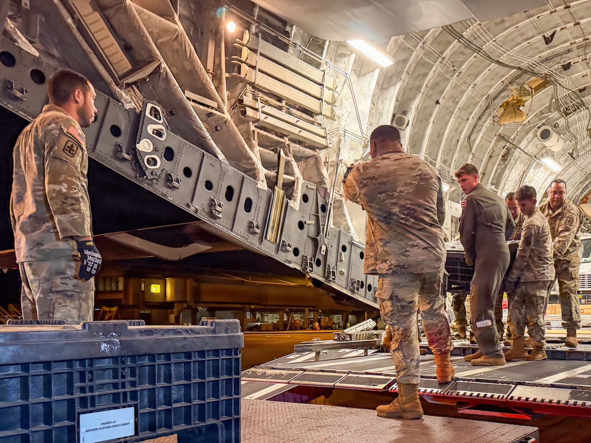 Photo of aircrew unloading pallets from a C-17