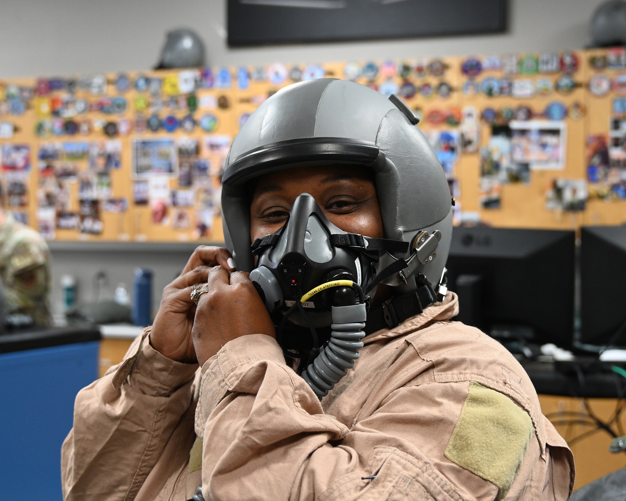 Sharon Johnson, Visit Columbus Bureau, Business Director, adjusts the oxygen mask straps of a head gear unit during uniform and equipment sizing in preparation for a T-6 Texan II orientation flight on June 6, 2026, at Columbus Air Force Base, Mississippi. Johnson was part of a new civic outreach and engagement initiative established by the installation commander, Col. James Blech, to immerse community leaders in the daily challenges of student pilots completing pilot training at Columbus AFB. (U.S. photo by Melissa Duncan-Doublin)