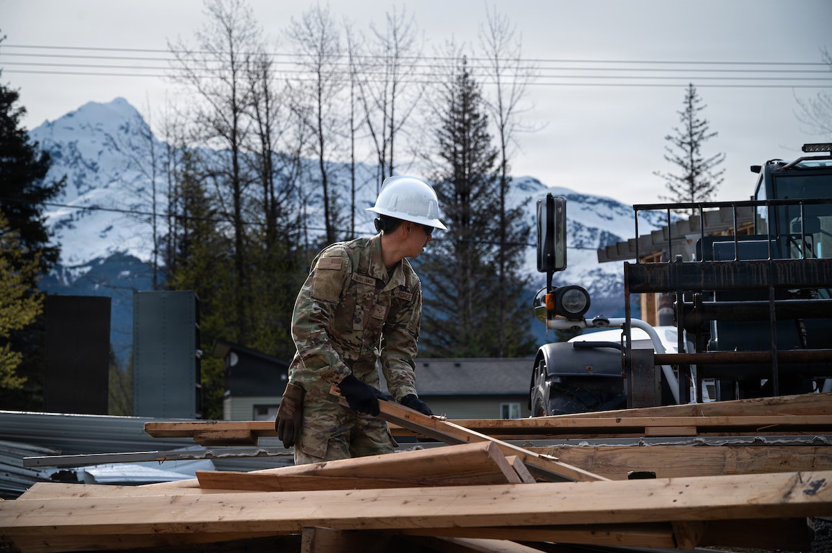 U.S. Air National Guard Senior Airman Jose Leon Castellanos, a structures specialist assigned to the 103d Civil Engineering Squadron, removes demolished lumber during a structural demolition project as part of a National Guard Bureau deployment for training, or DFT, project in Seward, Alaska, June 2, 2026.