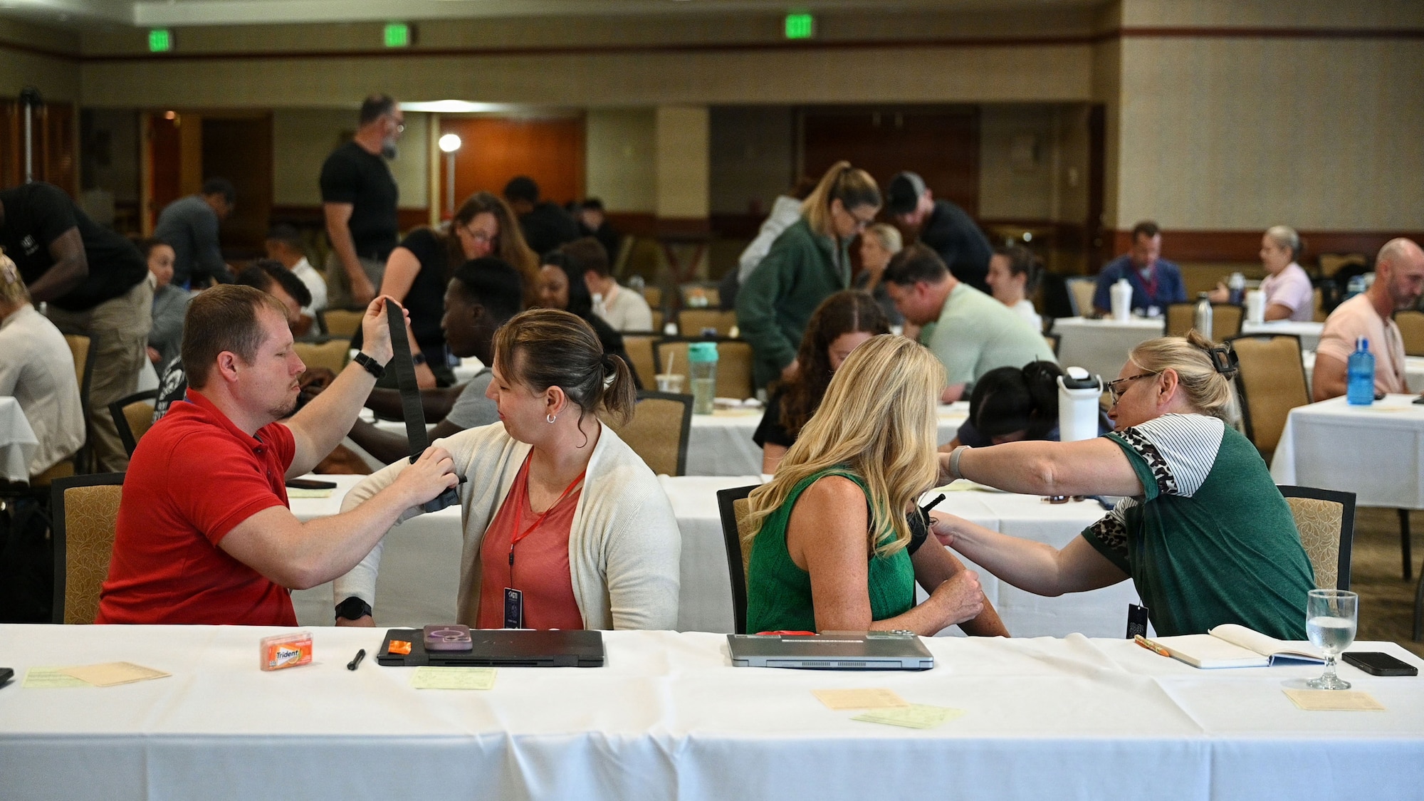 Students assigned to the 130th Airlift Wing’s Chemical, Biological, Radiological, Nuclear and Explosive Enhanced Response Force Package, or CERF-P, practice applying tourniquets on each other during the first day of the Armed Forces Advanced Trauma Training at the Hale Koa Hotel, Aug. 18, 2026.