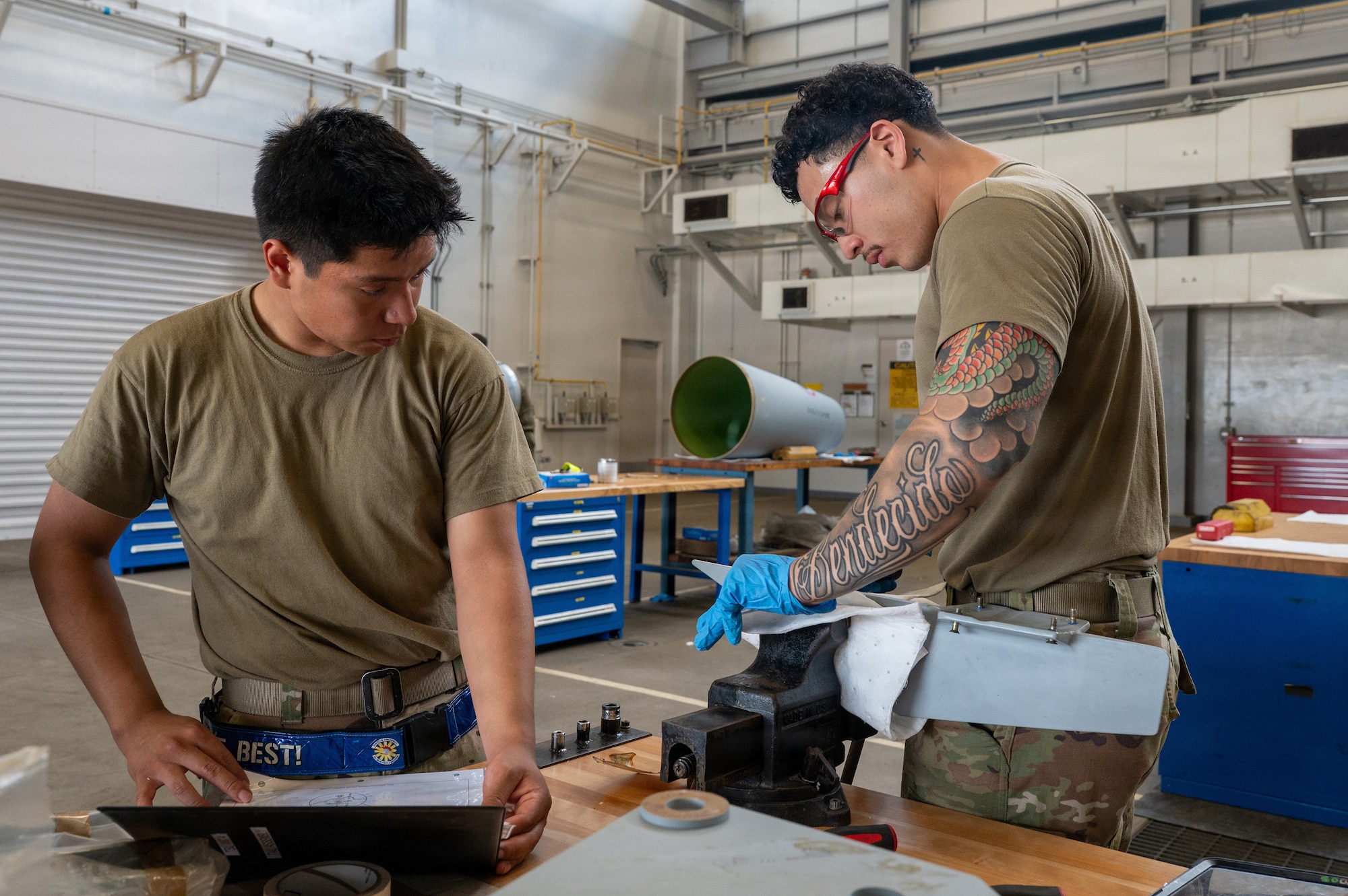 U.S. Air Force Airman 1st Class Christopher Perez-Vasquez, 35th Maintenance Squadron (MXS) aerospace propulsion apprentice, left, and Airman 1st Class Johan Coello Cano, 35th MXS electrical and environmental specialist, file a fin to ensure proper fitment to an F-16 Fighting Falcon external fuel tank during Nestable Fuel Tank Build Up (NFTBU) training at Misawa Air Base, Japan, Aug. 25, 2026. NFTBU training equips Airmen outside the fuel systems specialty to augment maintenance operations, expanding the 35th Fighter Wing’s capacity to sustain combat-ready aircraft during high-tempo operations. (U.S. Air Force photo by Airman 1st Class Angelica Winther)