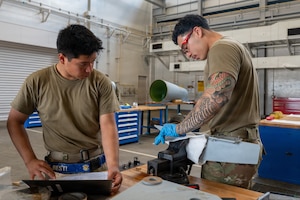 U.S. Air Force Airman 1st Class Christopher Perez-Vasquez, 35th Maintenance Squadron (MXS) aerospace propulsion apprentice, left, and Airman 1st Class Johan Coello Cano, 35th MXS electrical and environmental specialist, file a fin to ensure proper fitment to an F-16 Fighting Falcon external fuel tank during Nestable Fuel Tank Build Up (NFTBU) training at Misawa Air Base, Japan, Aug. 25, 2026. NFTBU training equips Airmen outside the fuel systems specialty to augment maintenance operations, expanding the 35th Fighter Wing’s capacity to sustain combat-ready aircraft during high-tempo operations. (U.S. Air Force photo by Airman 1st Class Angelica Winther)