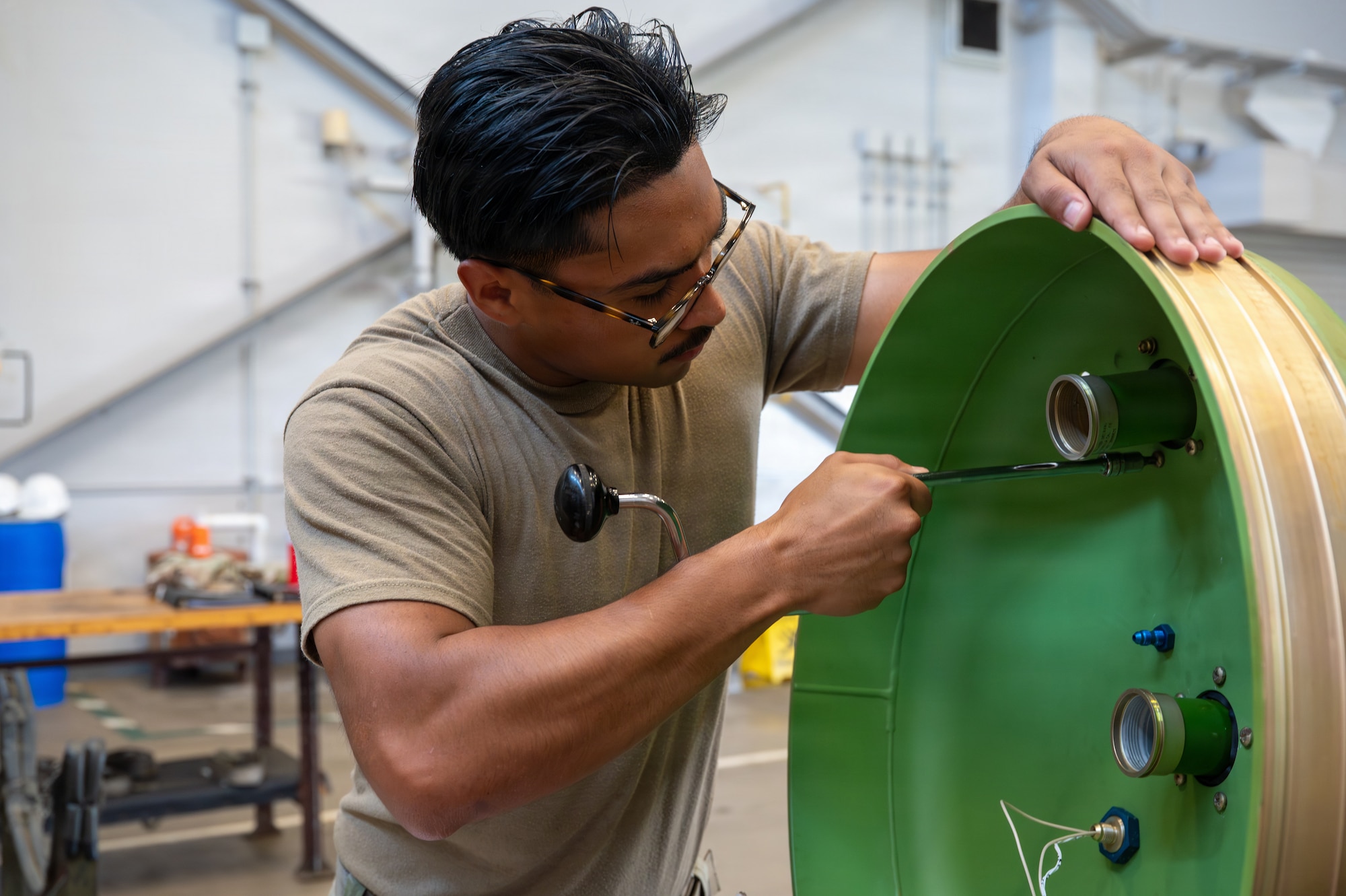 U.S. Air Force Airman Michael Vargas Chavez, 35th Maintenance Squadron aerospace ground equipment specialist, tightens hardware on an external fuel tank during Nestable Fuel Tank Build Up (NFTBU) training at Misawa Air Base, Japan, Aug. 25, 2026. By training maintainers from multiple specialties to support fuel tank assembly, NFTBU increases maintenance flexibility and strengthens the 35th Fighter Wing’s ability to generate combat airpower across the Pacific. (U.S. Air Force photo by Airman 1st Class Angelica Winther)