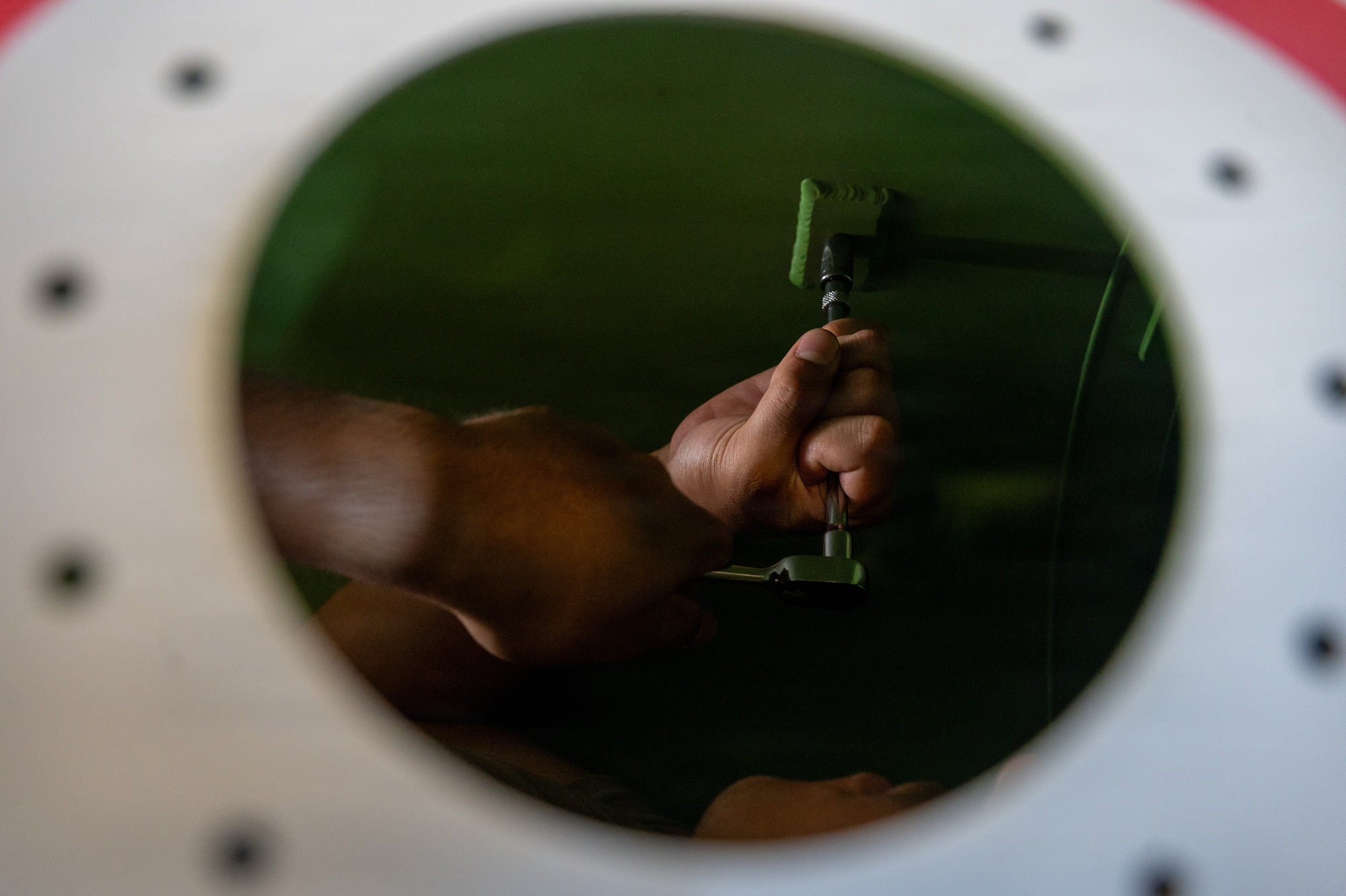 U.S. Air Force Airman secure components inside an external fuel tank during Nestable Fuel Tank Build Up (NFTBU) training at Misawa Air Base, Japan, Aug. 25, 2026. NFTBU training prepares personnel to rapidly assemble replacement fuel tanks, helping maintain aircraft availability and sustain combat operations across the Pacific. (U.S. Air Force photo by Airman 1st Class Angelica Winther)