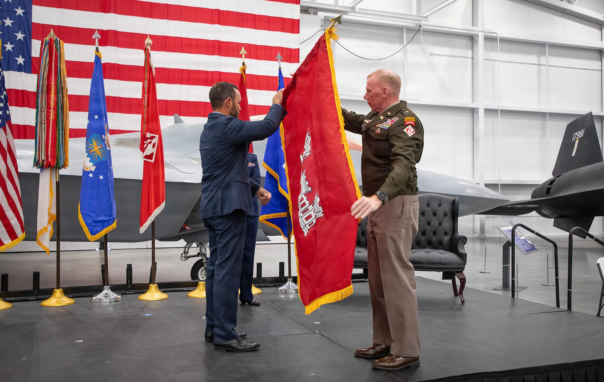 Pete Sturdivant, director of Intercontinental Ballistic Missile Infrastructure for the U.S. Air Force Nuclear Weapons Center (left), and Army Brig. Gen. William C. Hannan, Jr., commanding general of Joint Task Force Castle (right), uncase the unit colors. The U.S. Army Corps of Engineers and the U.S. Air Force activated Joint Task Force Castle in a ceremony at Hill Air Force Base, Utah, on July 16, 2026.