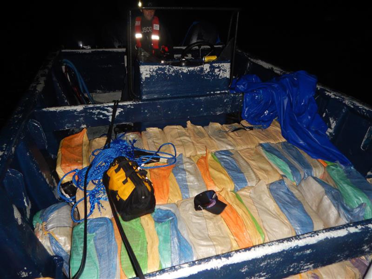 Bales of suspected drugs on the deck of a small boat.